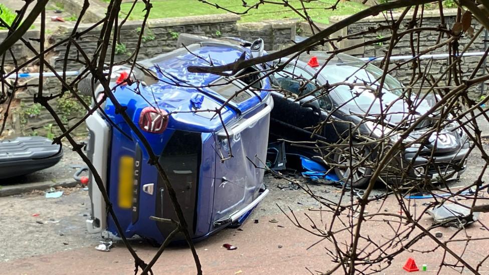 A range rover upside down on the road after the crash