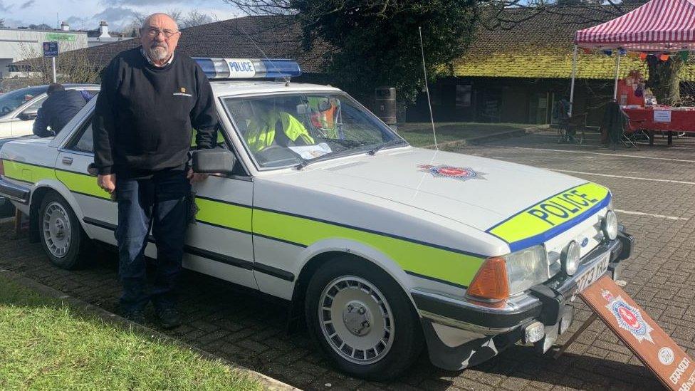 Brian Bedford stood with his police car