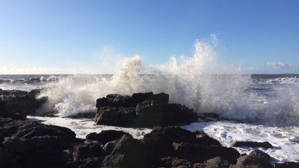 Waves crashing on rocks at Rest Bay in Porthcawl.