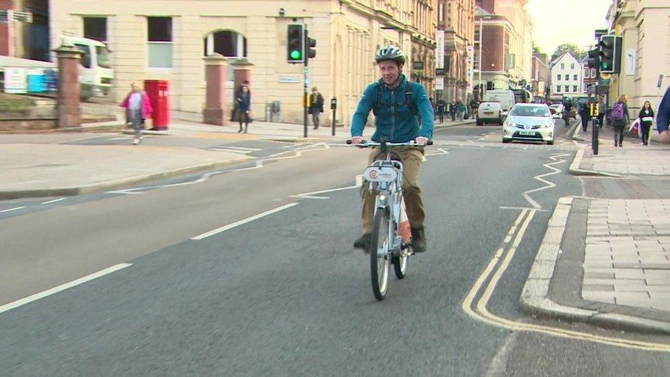 Someone riding an electric bike in Exeter.