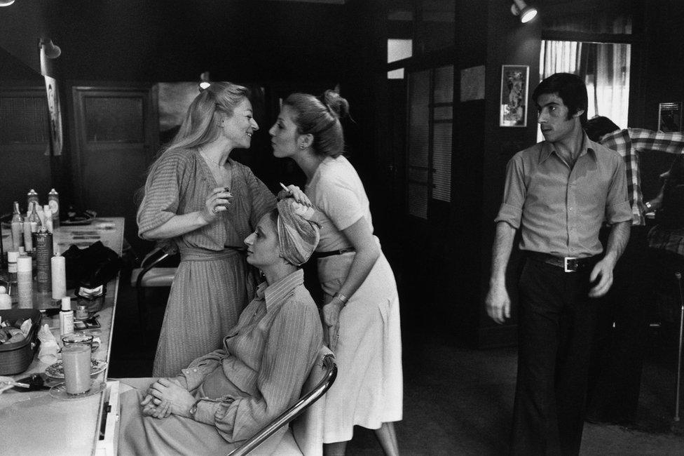 Two women greet each other inside a hair salon in Tehran in 1976