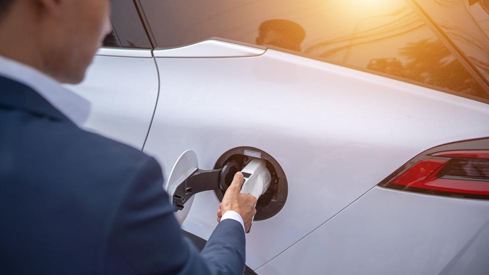 Electric car being charged