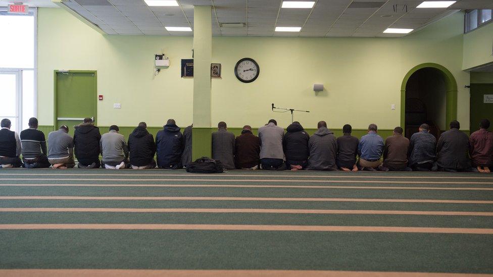 Men pray at the Quebec City mosque a year after the shooting