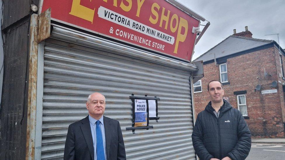 Shaun Trevor, of Darlington Trading Standards, and Detective Constable Jonathan Keenan, from Durham Constabulary, serving a closure notice to Easy Shop, on Victoria Road