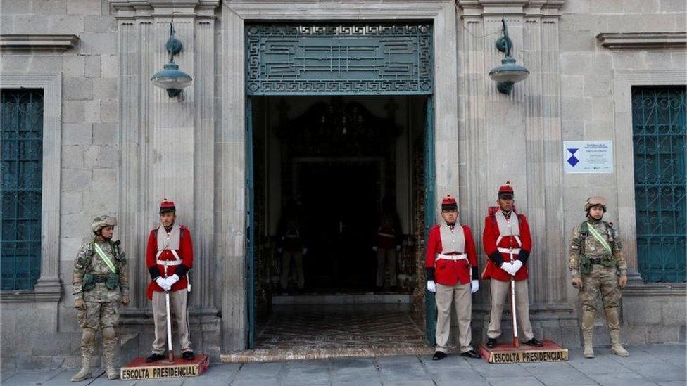 Military members stand guard at an entrance of the Presidential Palace in La Paz, Bolivia November 13, 2019.