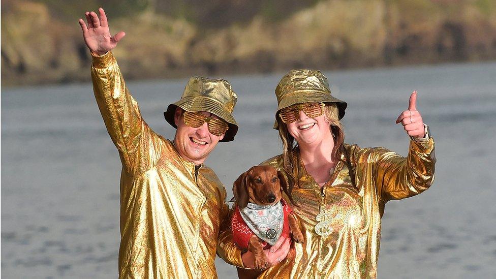 swimmers in fancy dress in sea