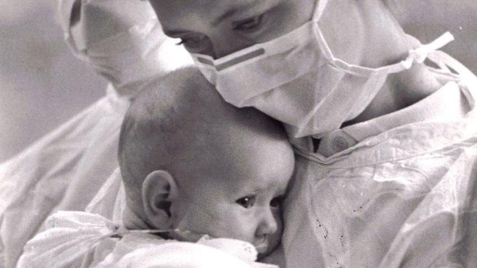 Carol holds baby Kaylee in hospital garb