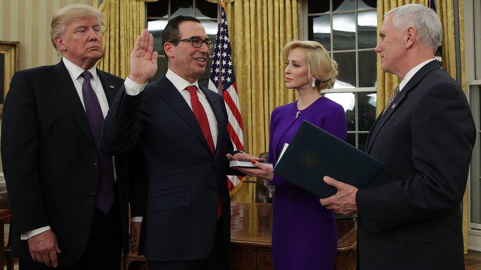 Former investment banker for Goldman Sachs Steven Mnuchin (2nd left) participates in a swearing-in ceremony, conducted by Vice President Mike Pence (right), as fiancée Louise Linton (3rd left) and President Donald Trump (left) look on in the Oval Office of the White House on 13 February 2017 in Washington, DC.