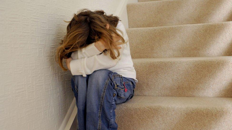 Young girl sitting on the stairs