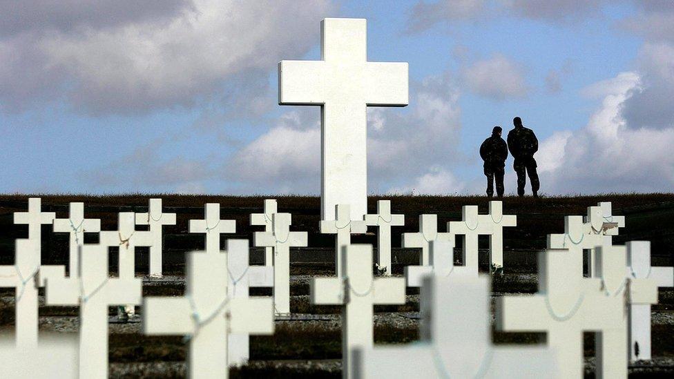 Two members of the British Army looking out over Goose Green from the Argentine memorial cemetery in Darwin on the Falkland Islands