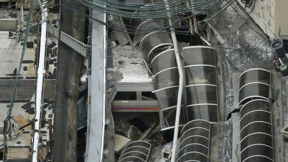 A derailed New Jersey Transit train is seen under a collapsed roof after it derailed and crashed into the station in Hoboken, New Jersey, U.S