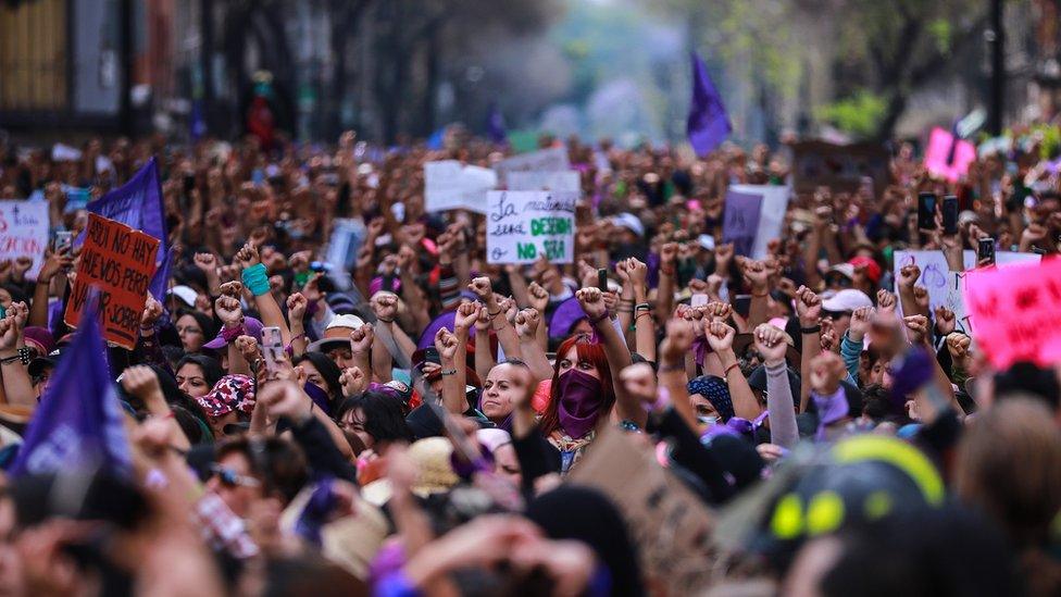 Women raise their fists during a protest on the International Women's Day in Mexico