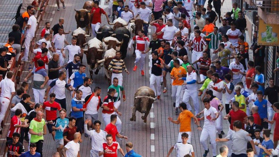 People take part in a bull run in San Sebastian de los Reyes, Madrid, Spain, 30 August 2023.