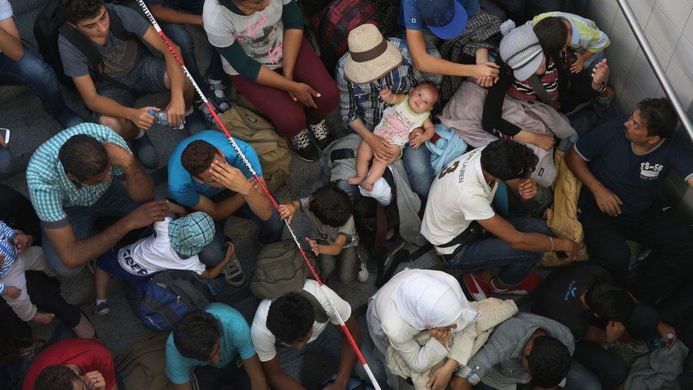 Lots of migrants, including a baby, at the railway station in Rosenheim, August 2015