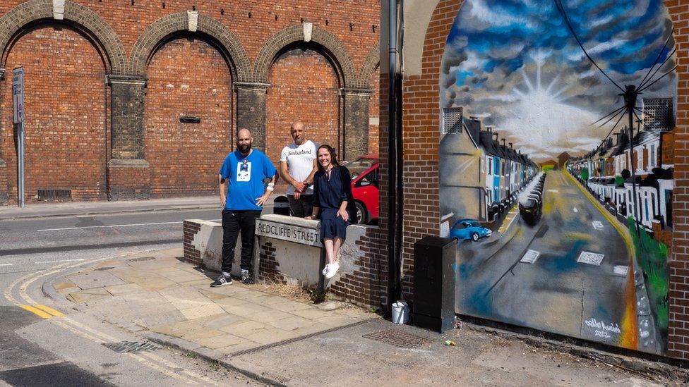 Steve Light, Marcello Assini and Helen Salter standing near the street sign