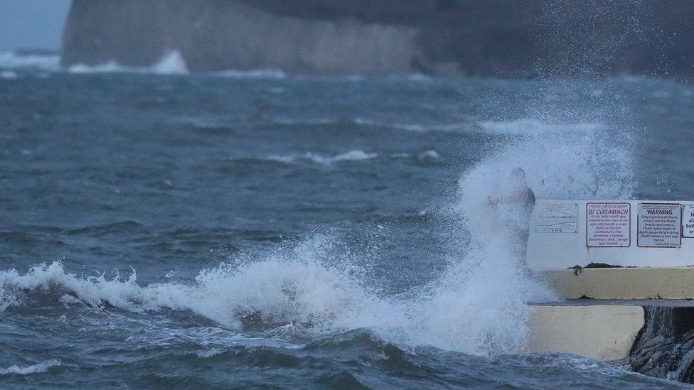 A man gets caught in a wave in Salthill, County Galway