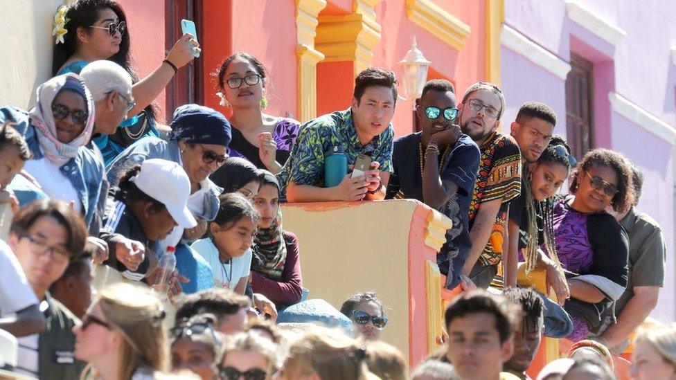 Crowds-gather-in-a-street-in South-Africa.