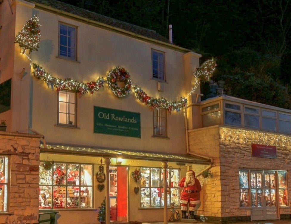 A Christmas gift shop with Christmas-holiday home above