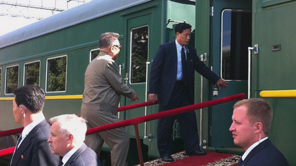 North Korean leader Kim Jong-Il enters his armoured carriage at the station of Novobureisky on August 21, 2011