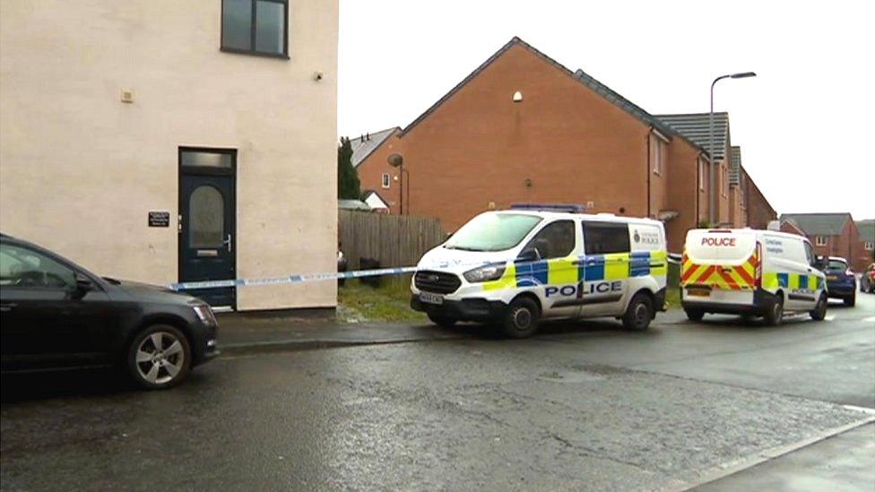 Police vehicles outside the property