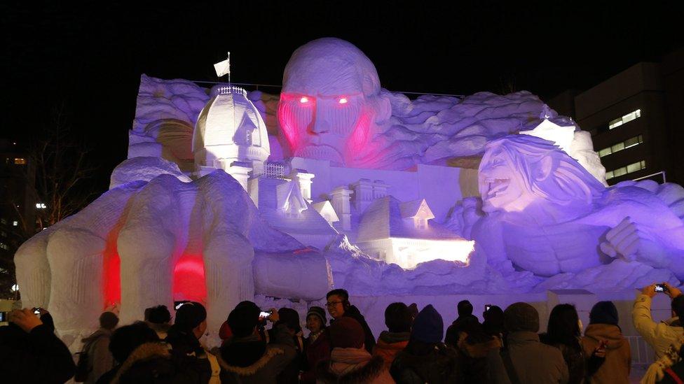 Purple lights make the sculptures glow at night time.