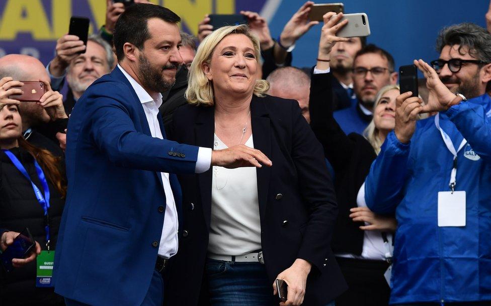 Italian Deputy Prime Minister and Interior Minister Matteo Salvini (L) and President of the French far-right Rassemblement National (RN) party Marine Le Pen react on stage at a rally of European nationalists ahead of European elections on May 18, 2019