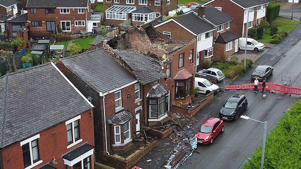 Aerial photograph of a house which had its roof ripped off during a localized tornado