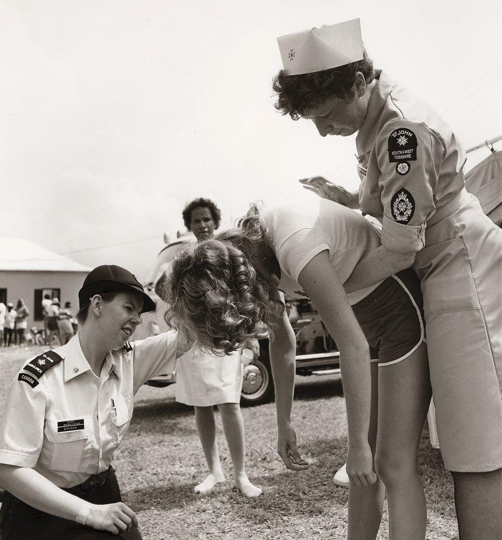 Volunteers demonstrate the Heimlich manoeuvre