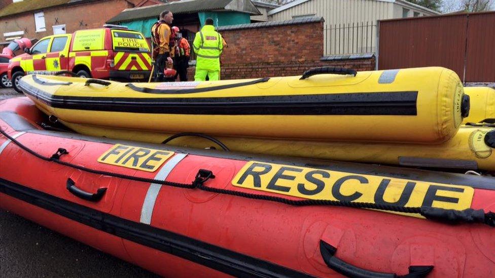 red and yellow inflatable boat in a village.