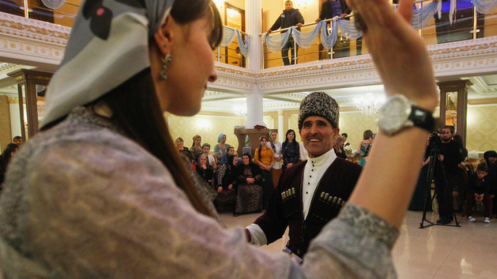 A man and woman dancing at a wedding in the Chechen capital Grozny