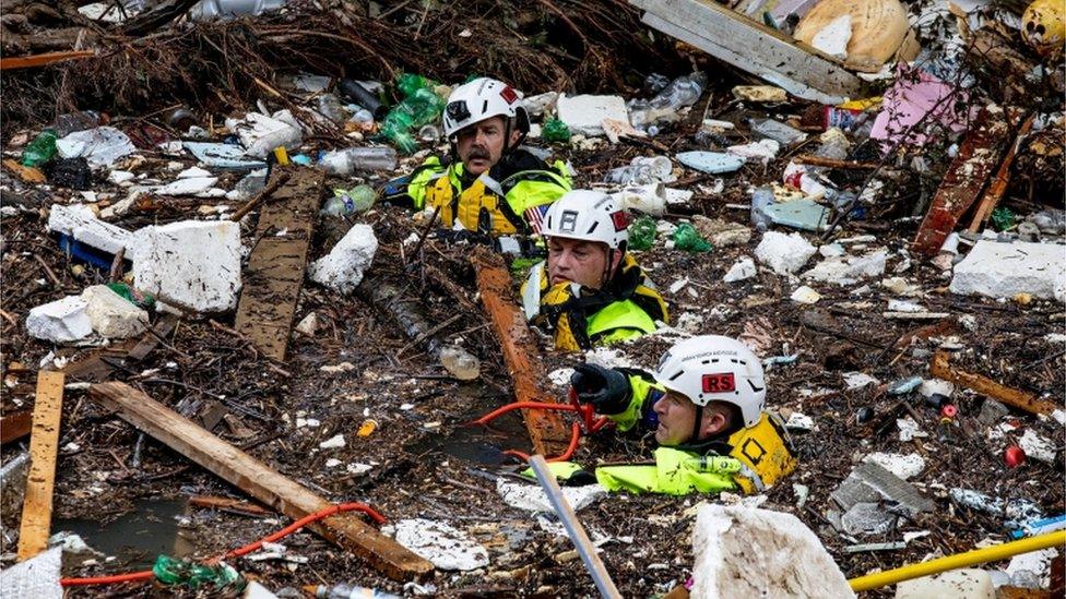 Rescuers search floodwaters for victims and survivors