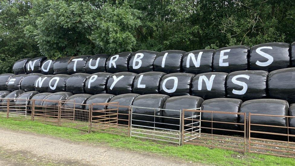 Signs against the Nant Mithil wind farm at the Royal Welsh Show in July