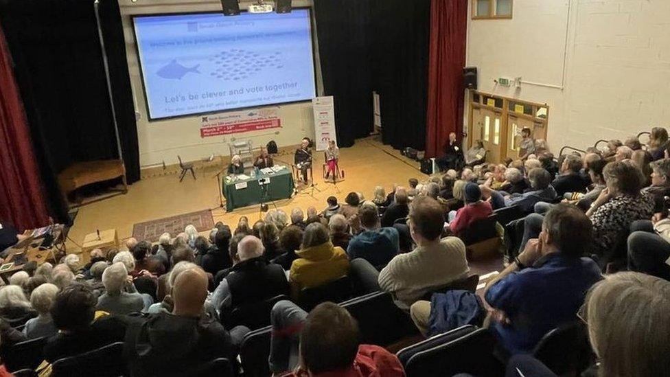 Audience listening to candidates