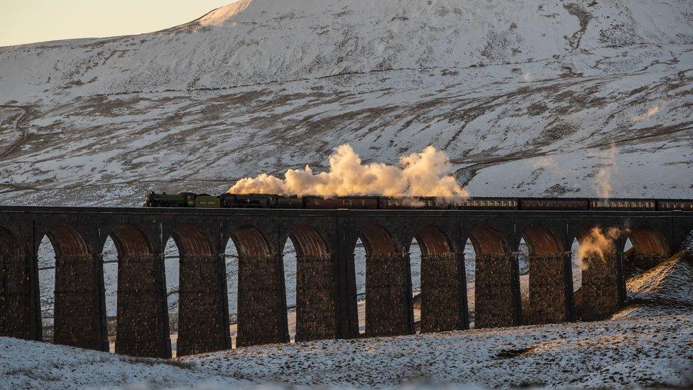 A train crosses the Ribblehead Viaduct amid wintry scenes in North Yorkshire.