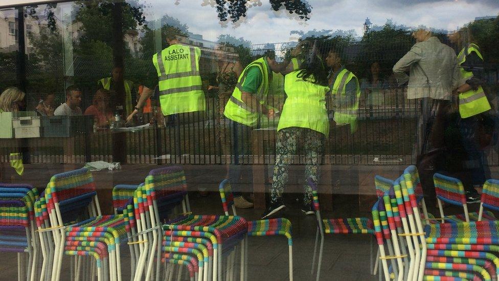 Staff wearing high visibility jackets inside Swiss Cottage leisure centre