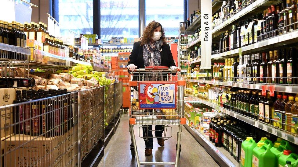 Customers wearing protective face masks shop at supermarket in Vienna, Austria on 1 April 2020