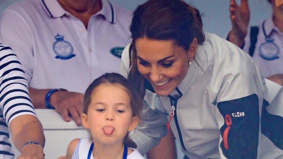 Princess Charlotte playfully sticks out her tongue while having fun with her mother