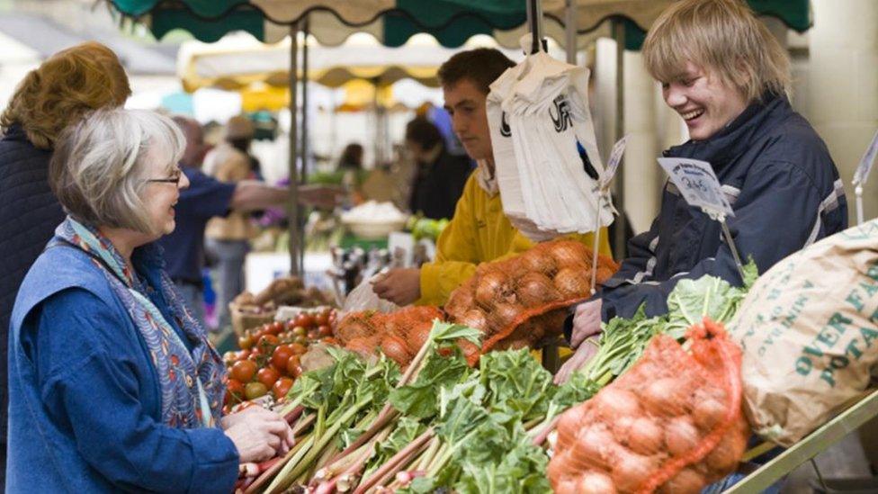 Customers at a stall at the farmers' market in Stroud