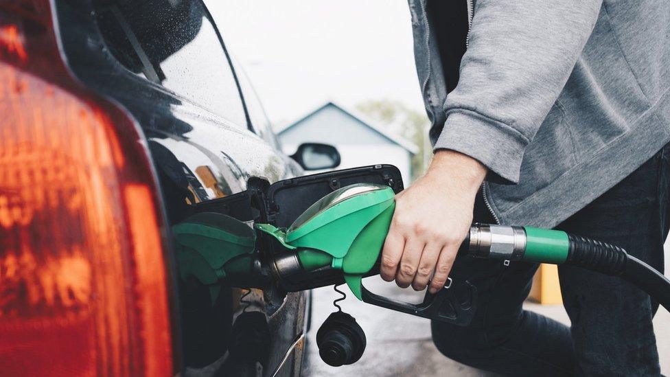 Man refueling car at fuel station