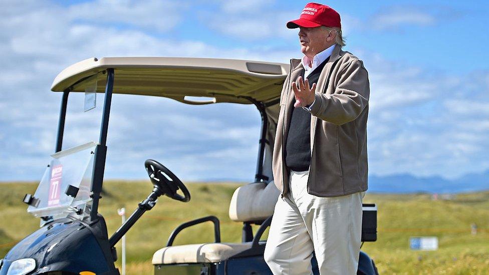 Donald Trump in front of a golf course