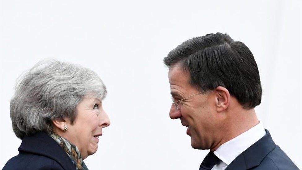 Theresa May is welcomed by Dutch Prime Minister Mark Rutte ahead of a meeting in the Hague,