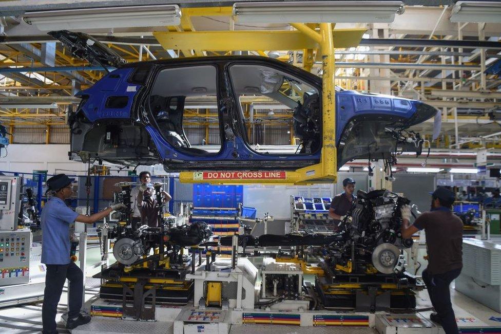 Workers assemble a car at a FCA India Automobiles manufacturing facility in Ranjangaon, some 200km east of Mumbai.