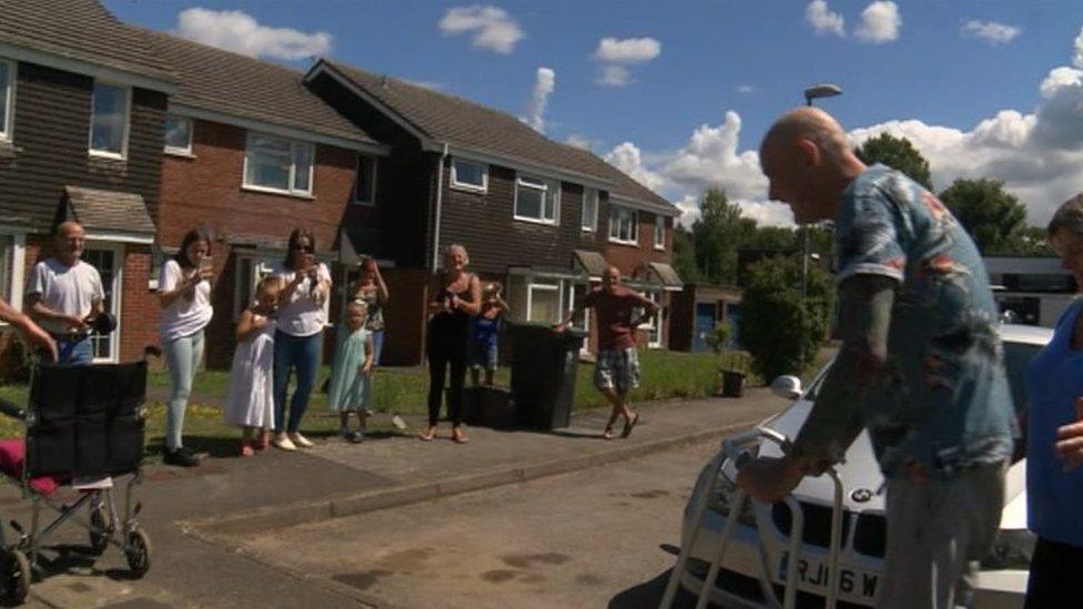 Ian Cobb being greeted as her returns home