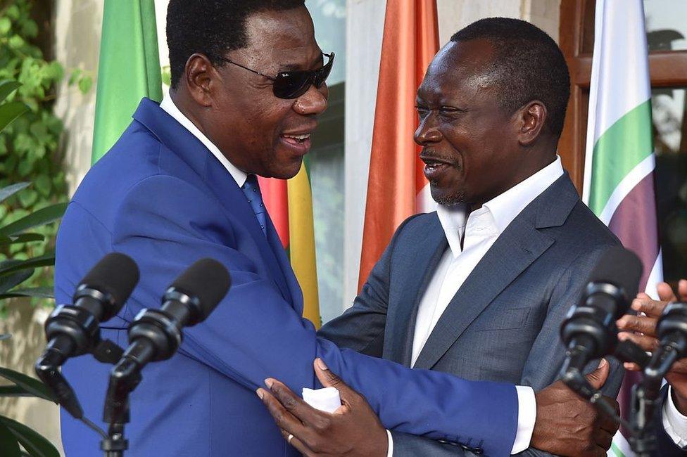 Former Beninese president Thomas Yayi Boni (L) embraces Benin's newly elected President Patrice Talon following a reconciliation meeting hosted by the Ivory Coast at the presidential residence in Abidjan, on 18 April 2016.