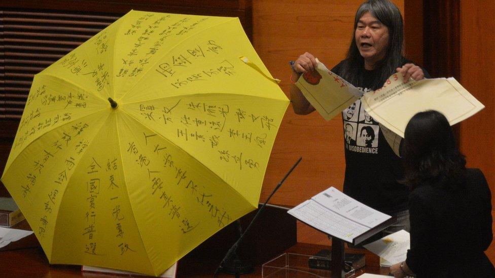 Leung Kwok-hung - known as 'Long Hair' - of the League of Social Democrats shouts slogans and rips up the '831 ruling' before taking the Legislative Council Oath at the first meeting of the Sixth Legislative Council (Legco) in Hong Kong on October 12, 2016