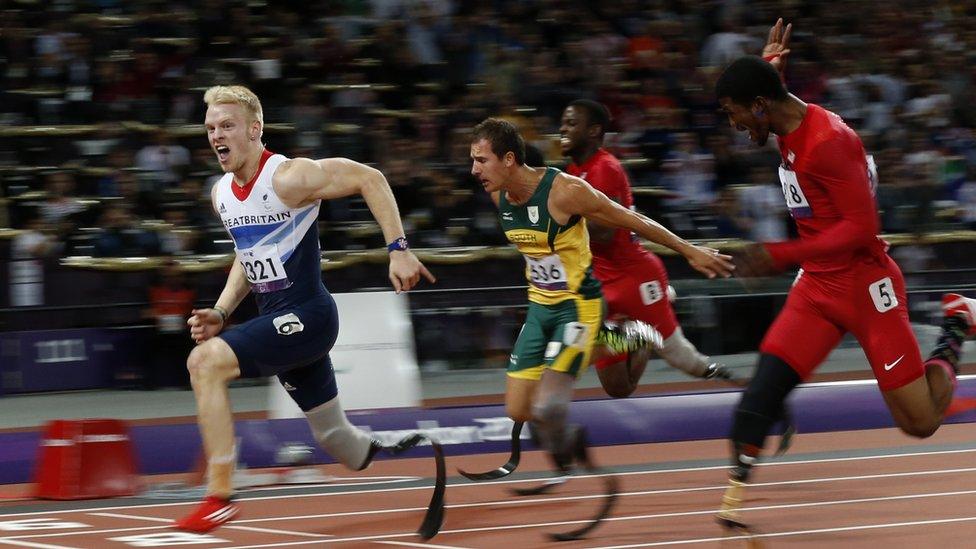 Gold medalist Britain's Jonnie Peacock, left, wins the men's 100m T44 category final during the athletics competition at the 2012 Paralympics