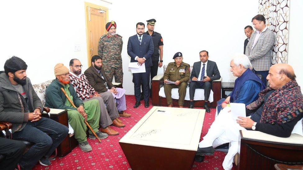 Defence Minister Rajnath Singh with the families of the three men