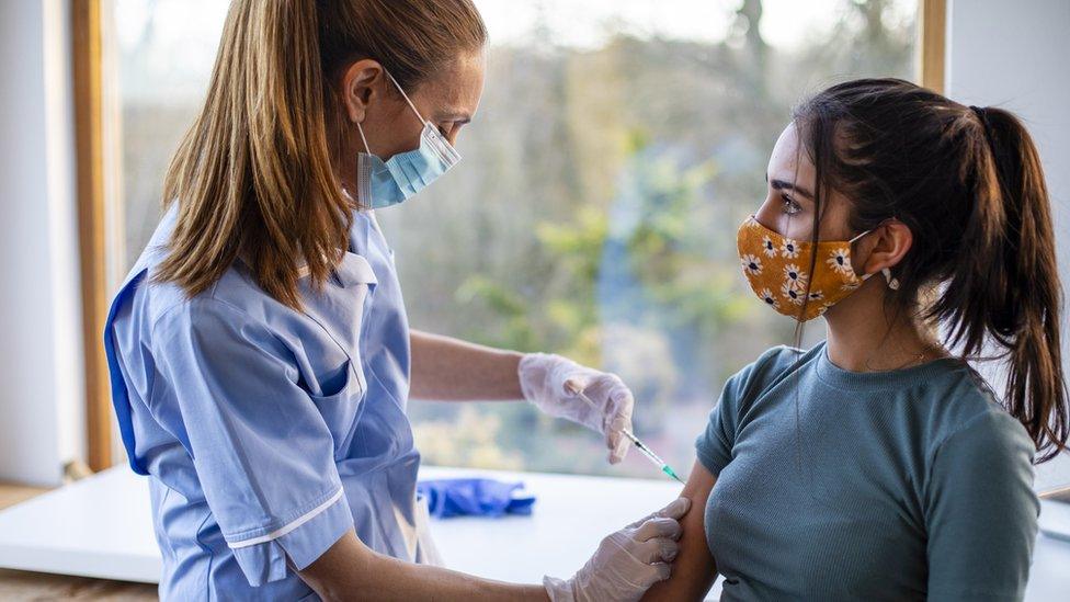 Girl receiving her Covid-19 vaccination from a nurse