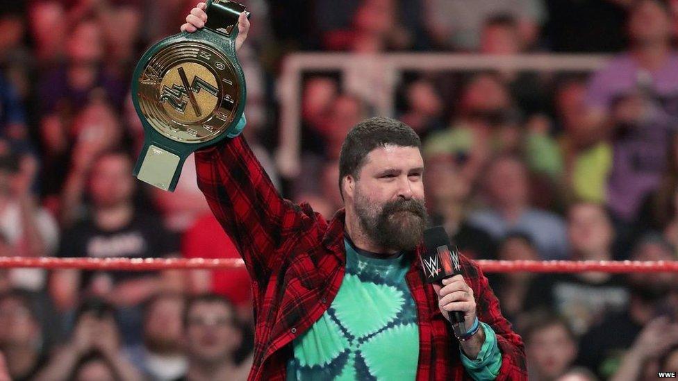 WWE Hall of Famer Mick Foley holding the all-new 24/7 Championship belt