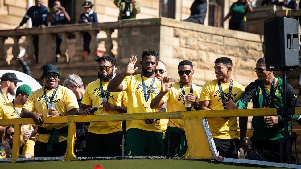 Springbok Rugby team captain Siya Kolisi (C) and the rest of the team greet the crowd as part of the trophy parade after the Springbok team won the 2023 Rugby World Cup, in Pretoria, South Africa, 02 November 2023.